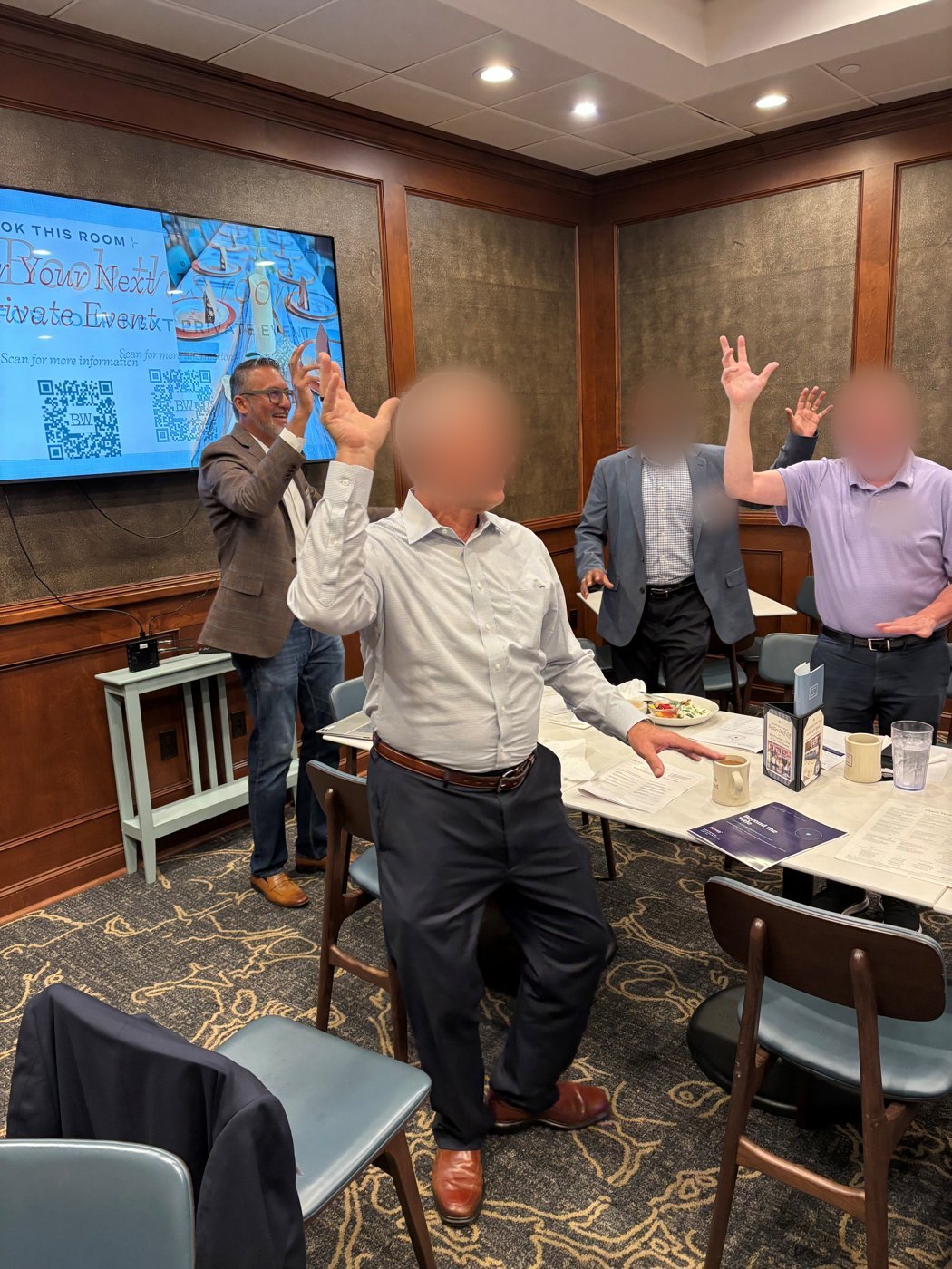 CIOs on their feet with hands raised during the movement exercise