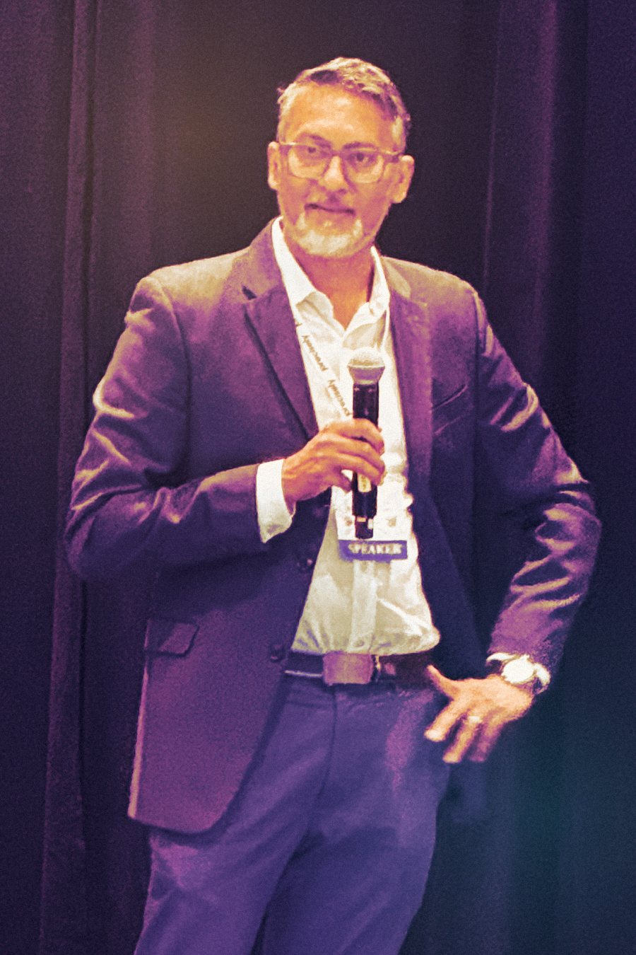 Abhi on stage with a microphone